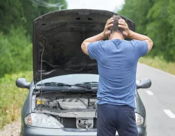 A car with a mechanical issue on the road
